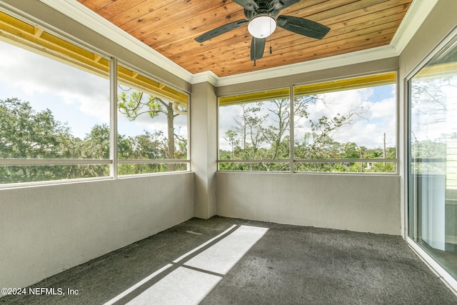 unfurnished sunroom with wood ceiling and ceiling fan