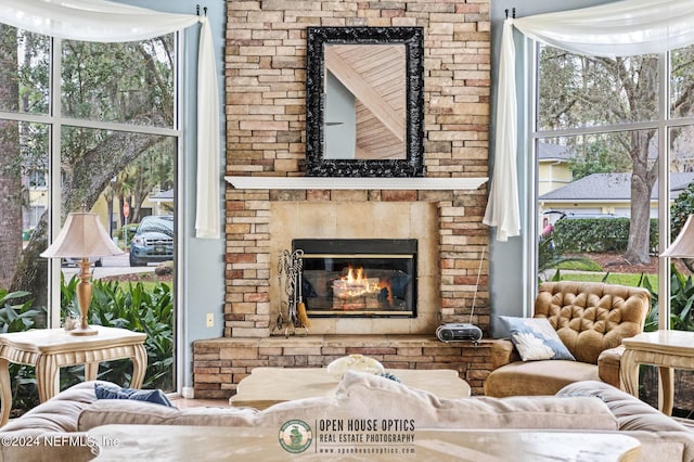 1800 The Greens Way Unit 1206, Jacksonville Beach, FL 32250 - interior space featuring a glass covered fireplace and a healthy amount of sunlight