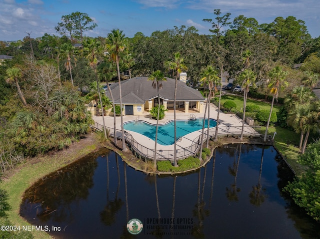 view of pool with a water view and a patio area