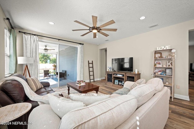 living room featuring hardwood / wood-style flooring and a textured ceiling