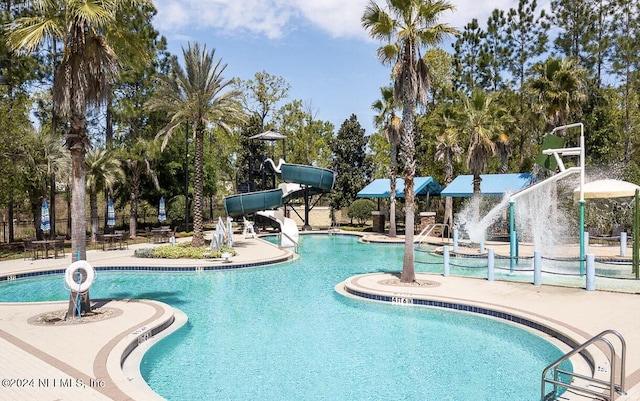 view of pool with pool water feature, a patio area, and a water slide