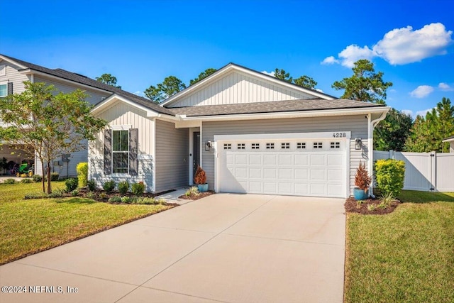 view of front of property with a garage and a front lawn