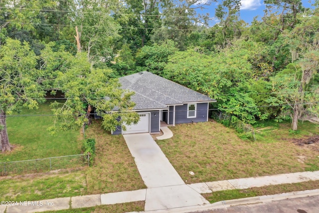 view of front of house featuring a front yard and a garage