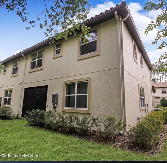 view of property exterior with a lawn