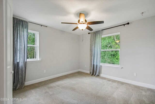 carpeted empty room with ceiling fan