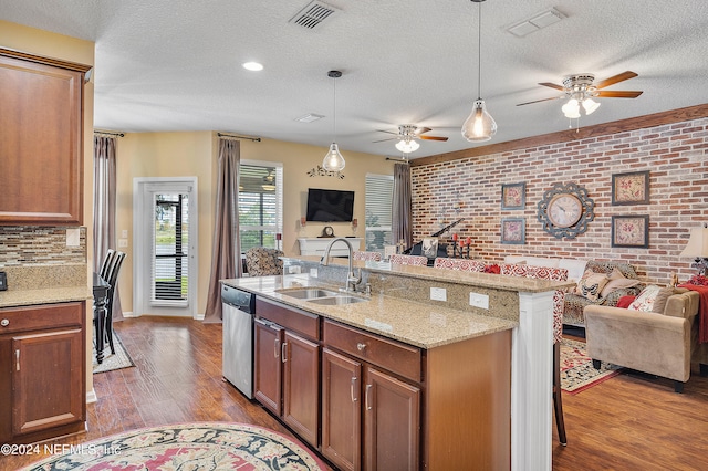 kitchen featuring dishwasher, ceiling fan, hardwood / wood-style floors, and sink