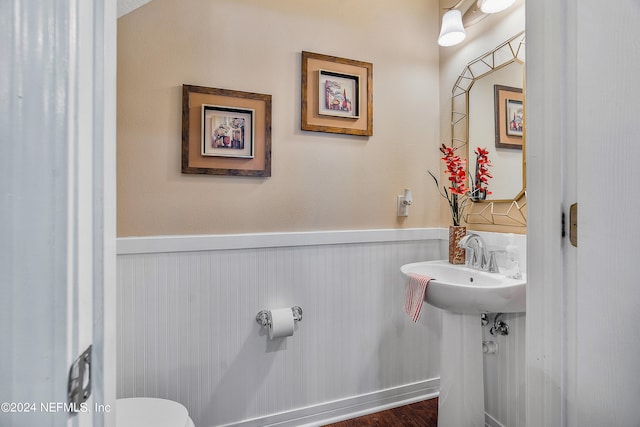 bathroom featuring hardwood / wood-style floors and toilet