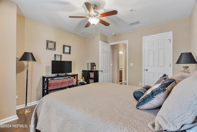 bedroom with wood-type flooring, a textured ceiling, and ceiling fan