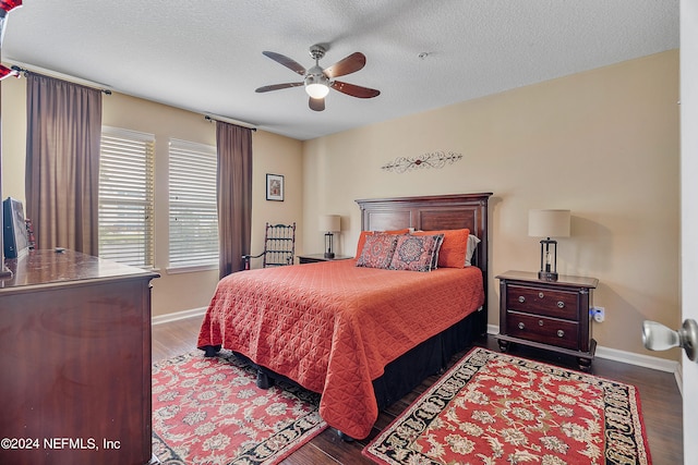 bedroom with a textured ceiling, dark hardwood / wood-style floors, and ceiling fan