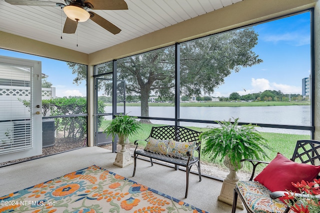 sunroom with ceiling fan, wood ceiling, a water view, and a healthy amount of sunlight