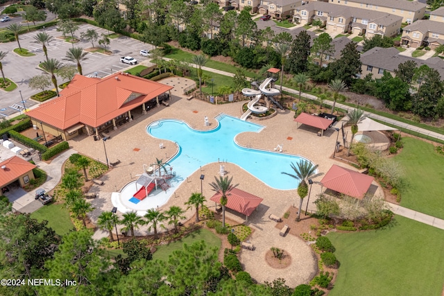 view of swimming pool with a patio and a water slide