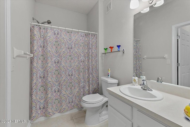 bathroom featuring tile patterned flooring, vanity, and toilet