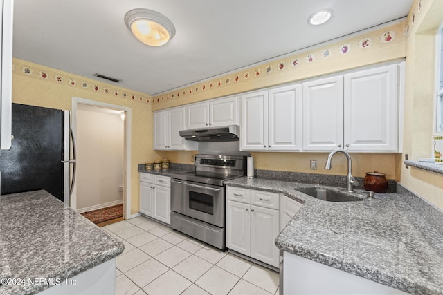 kitchen featuring electric range, white cabinets, sink, and black refrigerator