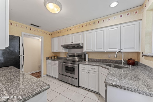 kitchen with refrigerator, sink, white cabinetry, stainless steel electric range oven, and light tile patterned floors