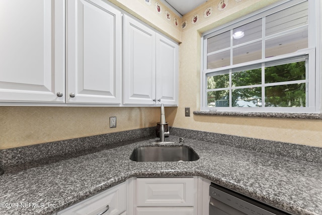 kitchen with white cabinets, sink, tasteful backsplash, dishwasher, and dark stone counters