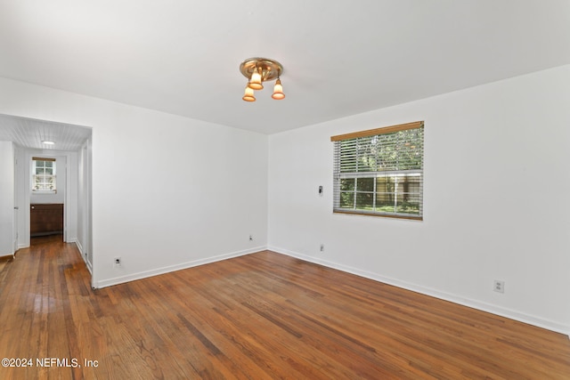 empty room with dark hardwood / wood-style flooring