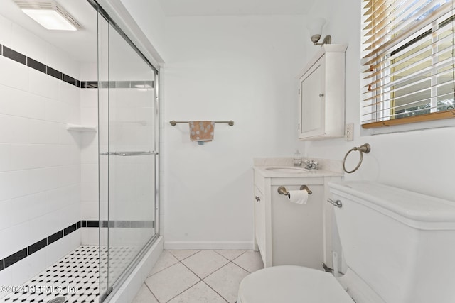 bathroom featuring vanity, a shower with shower door, toilet, and tile patterned flooring