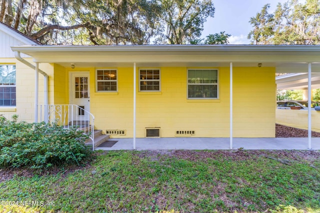 back of house with a carport