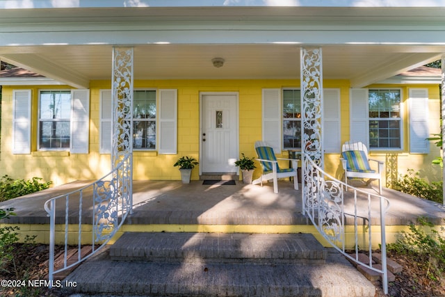 doorway to property featuring covered porch