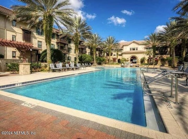 view of swimming pool featuring a patio area