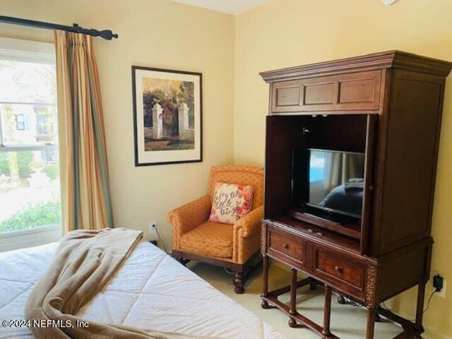 bedroom featuring light carpet