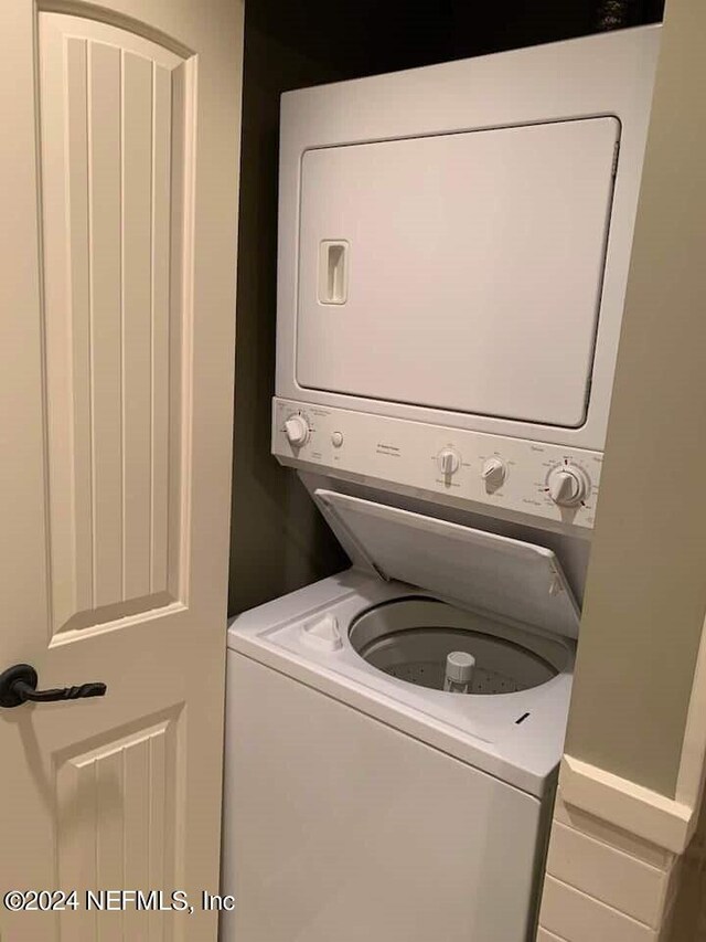 washroom with stacked washer / drying machine