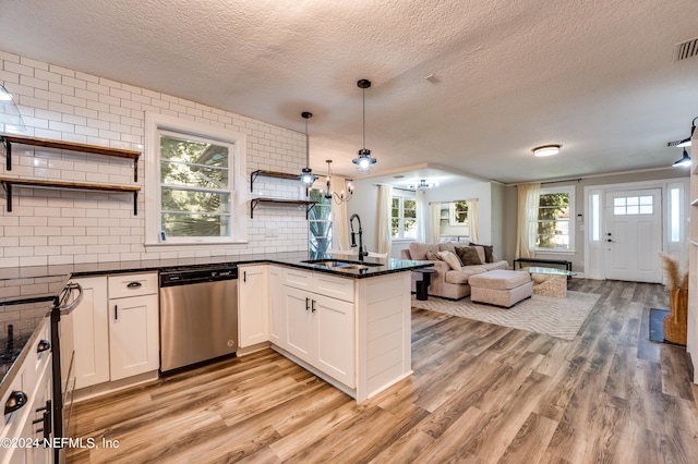 kitchen with sink, plenty of natural light, white cabinetry, and stainless steel dishwasher