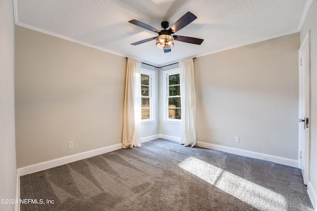 carpeted empty room featuring ornamental molding, ceiling fan, and a textured ceiling