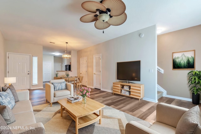 living room with ceiling fan and wood-type flooring