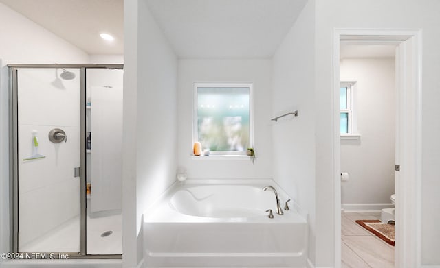 bathroom featuring separate shower and tub, tile patterned floors, and toilet