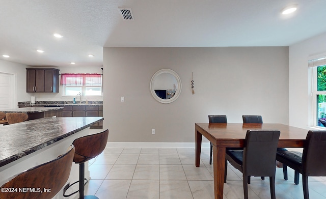 dining area with sink and light tile patterned floors