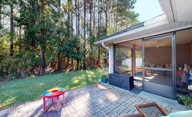 view of patio featuring a sunroom and ceiling fan