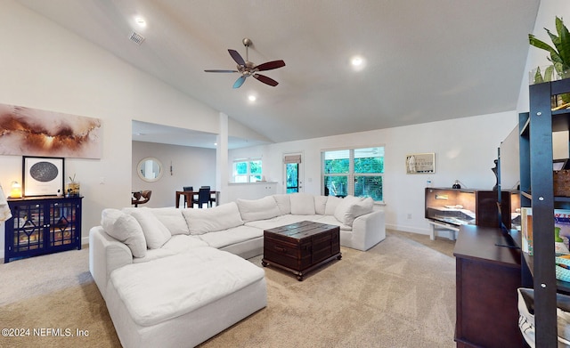 carpeted living room featuring ceiling fan and high vaulted ceiling