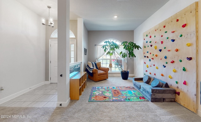 playroom featuring an inviting chandelier and light colored carpet