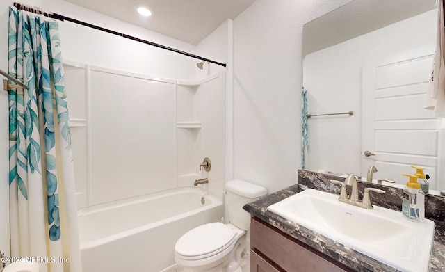 full bathroom featuring shower / tub combo, vanity, and toilet