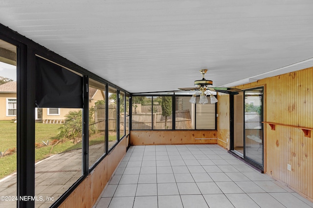 unfurnished sunroom with ceiling fan