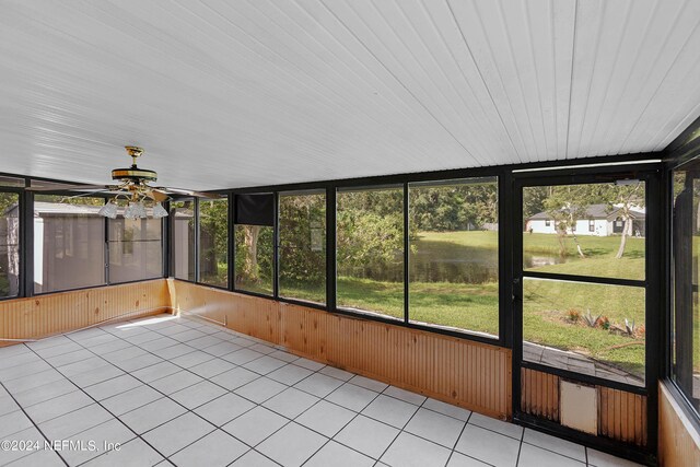 unfurnished sunroom with ceiling fan