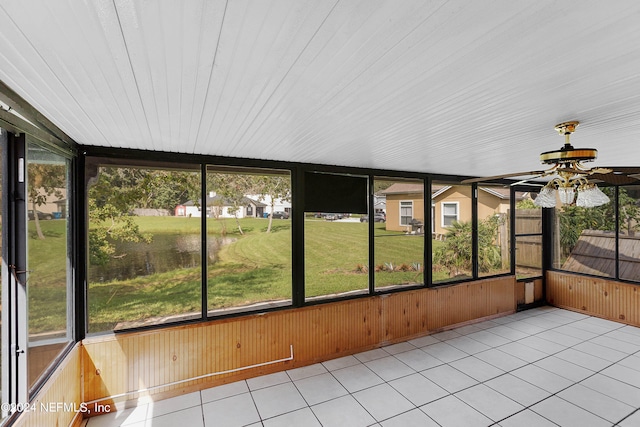 unfurnished sunroom featuring ceiling fan and a wealth of natural light