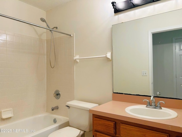 full bathroom featuring vanity, a textured ceiling, toilet, and washtub / shower combination