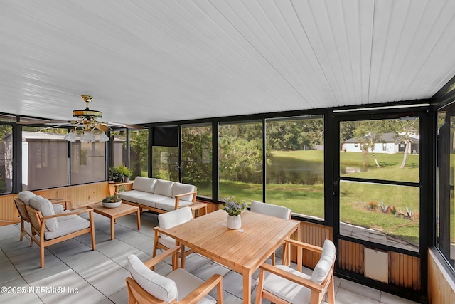 sunroom featuring a water view, a healthy amount of sunlight, and ceiling fan