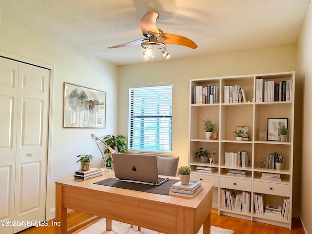 office featuring ceiling fan, a textured ceiling, and light wood-type flooring