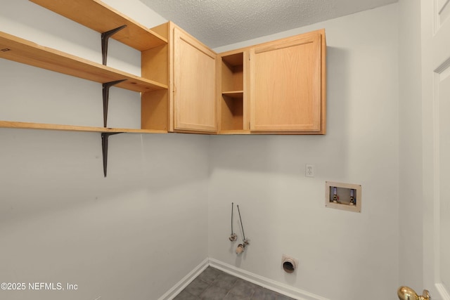 washroom with hookup for a washing machine, hookup for a gas dryer, hookup for an electric dryer, a textured ceiling, and baseboards