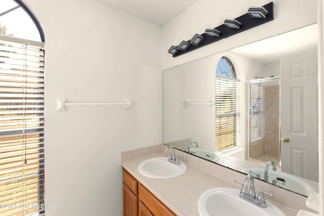 bathroom featuring vanity and a shower with shower door