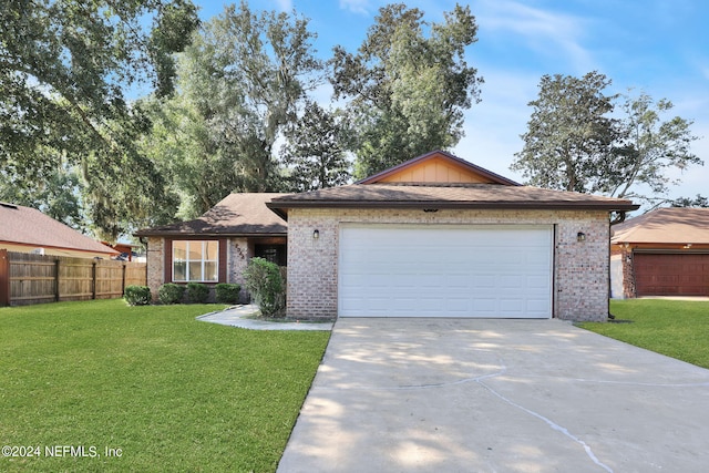 ranch-style home with a garage and a front yard