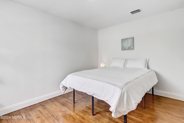 bedroom with wood-type flooring