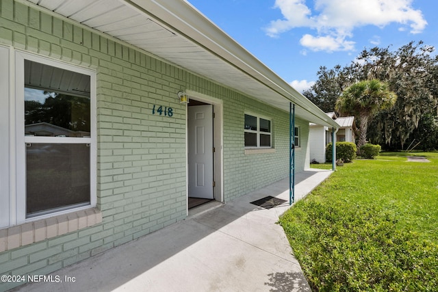 doorway to property featuring a yard