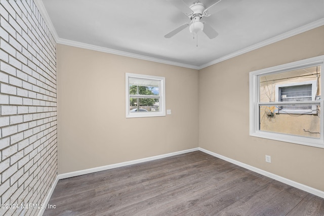 spare room with ceiling fan, crown molding, and dark wood-type flooring