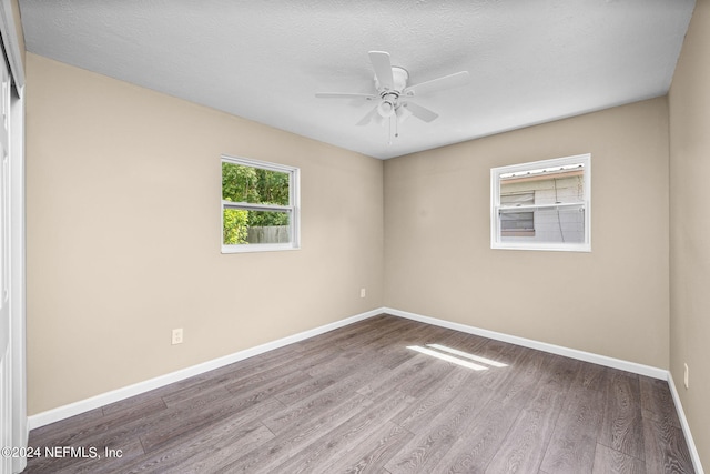 unfurnished room featuring a textured ceiling, ceiling fan, and hardwood / wood-style flooring