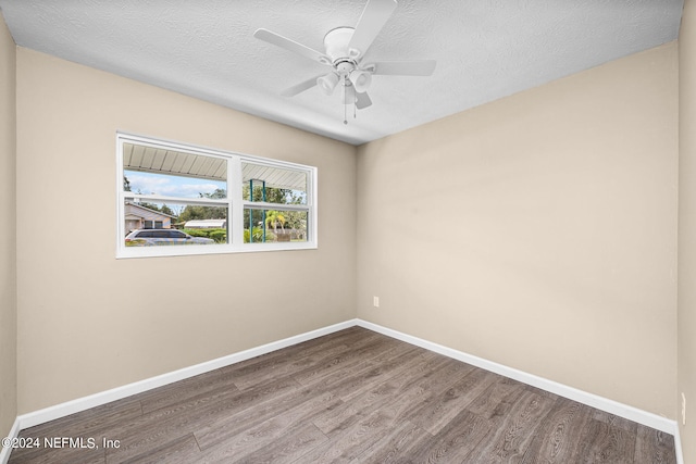 empty room featuring wood-type flooring, a textured ceiling, and ceiling fan