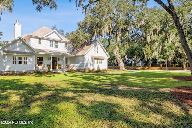 view of front facade with a front yard and covered porch